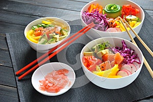 Poke bowls with fresh salmon, crystal noodles, radish, avocado, sweet pepper, cucumber, sesame seeds, red cabbage