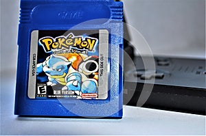 Pokemon Blue GameBoy and game 2 sideview