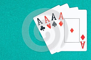 Poker aces cards on green gaming table