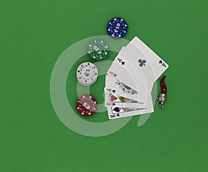 Poker cards and amulete on a green table
