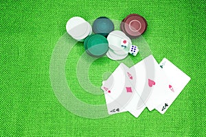 Poker cards on a green table with dice and chips