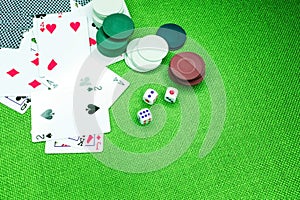 Poker cards on a green table with dice and chips