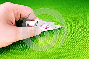 Poker cards on a green table with dice and chips