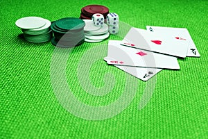 Poker cards on a green table with dice and chips