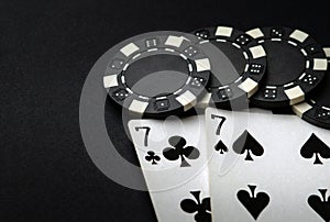 Poker cards with one pairs winning combination in casino. Chips and cards on the black table