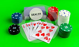 Poker, cards with a royal flush combination on a green table