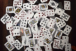Poker cards scattered on a table, card mix. cards for magic trick