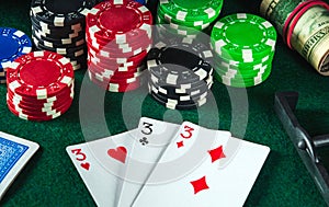 Poker cards with three of a kind or set combination in casino. Chips and money on the green table