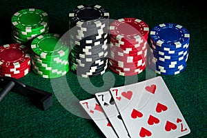 Poker cards with three of a kind or set combination in casino. Chips and rake on the green table