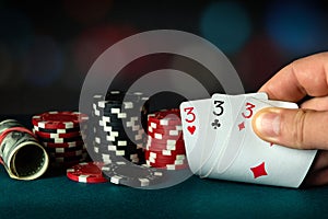 Poker cards with three of a kind or a set combination. The player hand holds a winning combination in a game in a poker club