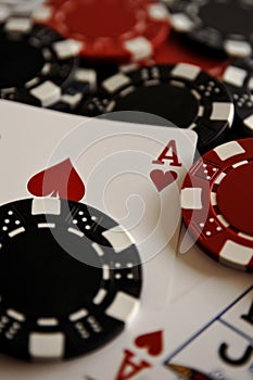 Poker chips and cards on a black table. Close-up