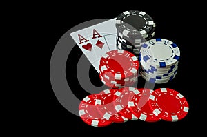 Poker chips and cards in a casino on a black background