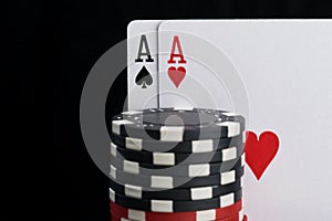 Poker chips and cards, close-up on a black background