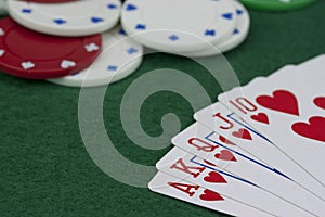 Poker chips and cards on a green table
