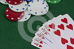 Poker chips and cards on a green table