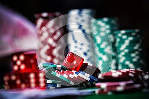 Poker Chips in casino gamble green table.