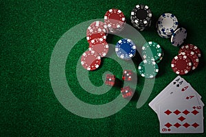 Poker Chips on casino gamble green table, dark tone.