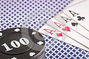 Poker chips and a combination of four aces