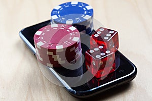 Poker Chips and Dices on top of cell phone