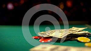 Poker chips and dollars lying on green table, poker and blackjack casino games photo