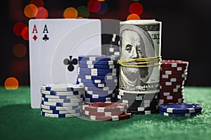 Poker chips, dollars and a pair of aces