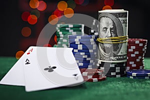 Poker chips, dollars and a pair of aces