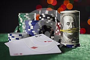 Poker chips, dollars and a pair of aces