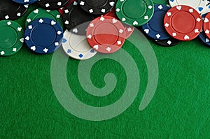 Poker chips forming a borde with a green background photo