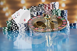 Poker Chips on gaming table, roulette wheel in motion, casino background