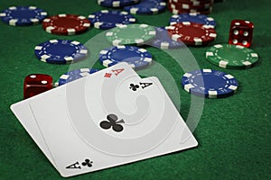 Poker chips and a pair of aces