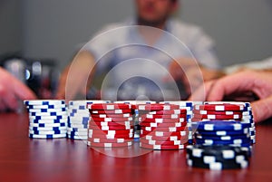 Poker Chips with Players in Background