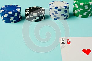 Poker chips and playing cards on colorful background