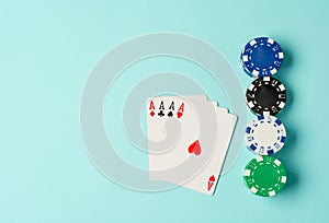 Poker chips and playing cards on colorful background