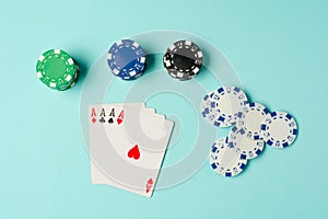 Poker chips and playing cards on colorful background