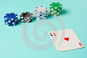 Poker chips and playing cards on colorful background