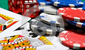 Poker chips, playing cards and dice on a green backgrorund. gambling