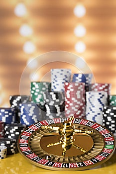 Poker Chips, Roulette wheel in motion, casino background