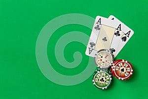 Poker chips stack and playing cards - two aces on green table