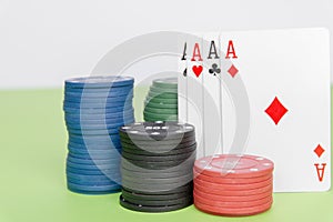 poker chips stack with two cards an ACE. On the green table on white background