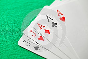 Poker combination of full house cards, three aces and two jacks, selective focus