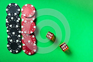 Poker dice with winning combination of eleven on green table and chips. Club atmosphere while playing Craps