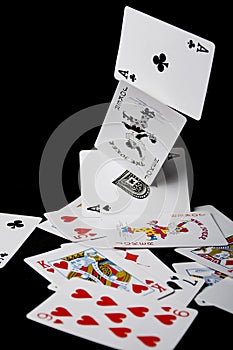 Poker falling cards on black background. Joker and black 2 ace cards