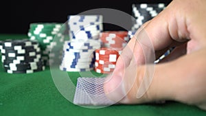 Poker game with a pair of duces betting all the poker chips. Close-up of a gambler hand is holding playing cards in