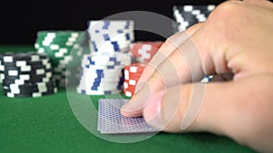 Poker game with a pair of eights betting all the poker chips. Close-up of a gambler hand is holding playing cards in