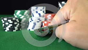 Poker game with a pair of kings betting all the poker chips. Close-up of a gambler hand is holding playing cards in