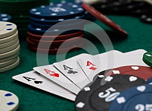 poker game table, four aces with stack of playing chips