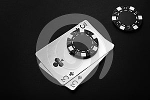 A poker game with a winning combination of one pair. Chips and playing cards on a black table