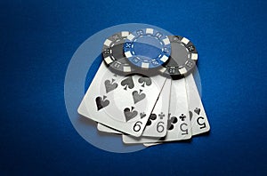 Poker game with a winning combination of two pairs. Playing cards and chips on a blue table in a poker club. Advertising space