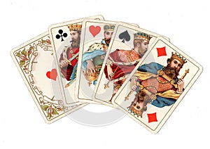 A poker hand of antique playing cards showing four kings.