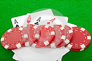 Poker hand of four aces playing cards and chips